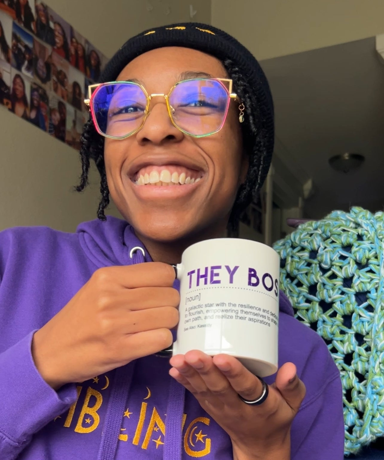 Kassidy smiling and holding a they boss mug