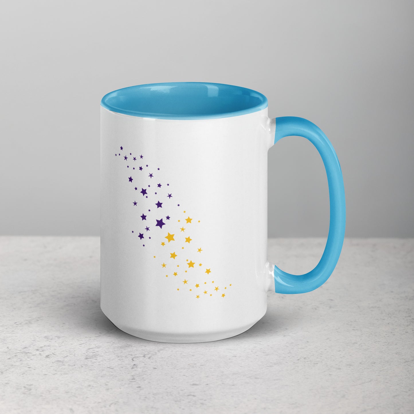 White mug with blue interior and handle, featuring purple and yellow star patterns on a light gray background.