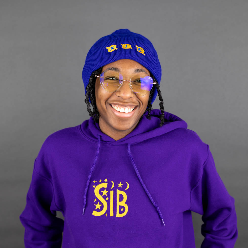 Kassidy wearing a royal blue 'xie' beanie