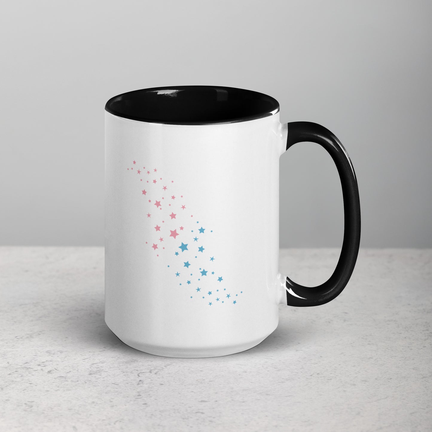 Back view of white ceramic mug with black handle and interior, featuring a celestial pattern of pink and blue stars arranged diagonally; designed by Galactic Flow for cosmic self-expression