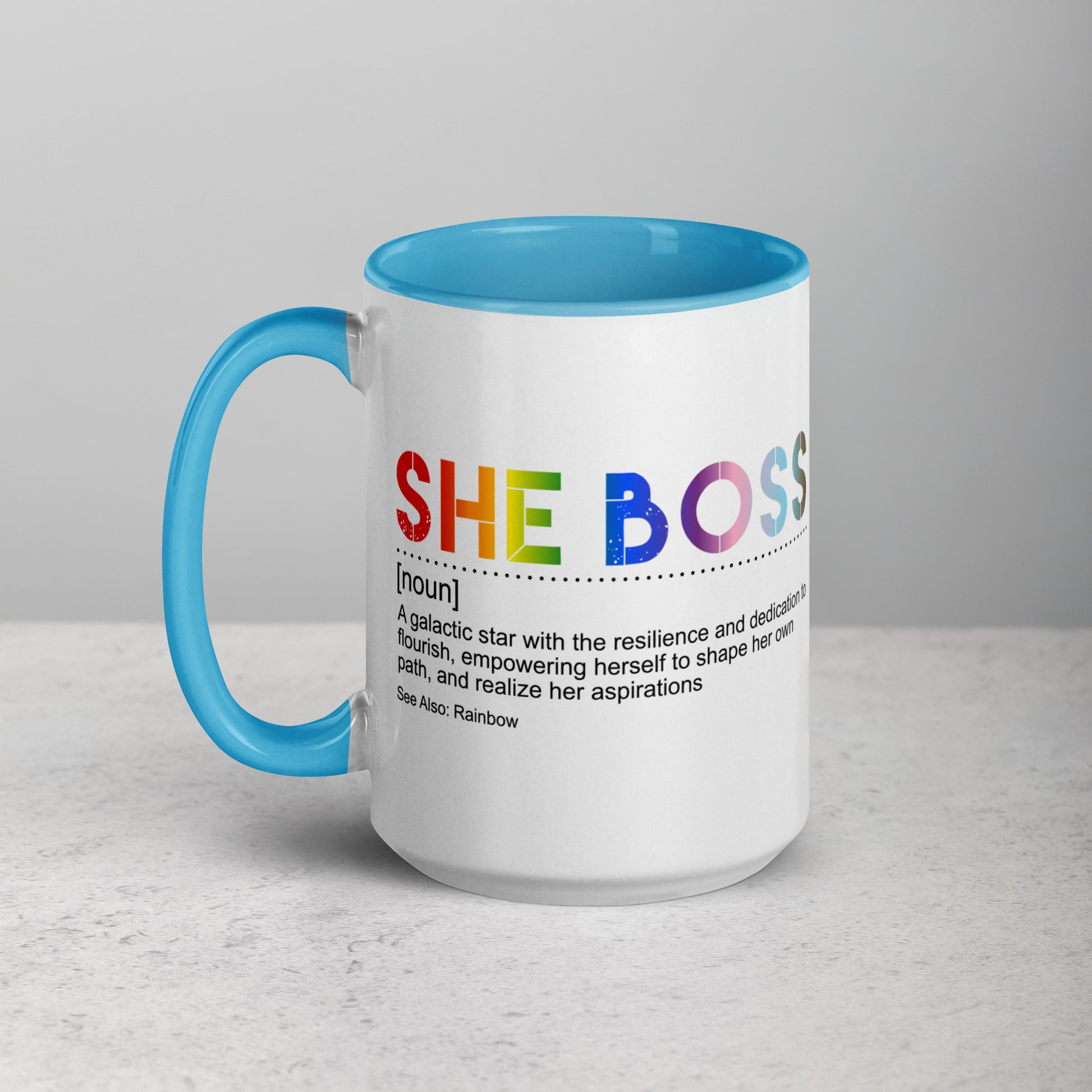 Mug with 'SHE BOSS' in pride-colored text on a gray background