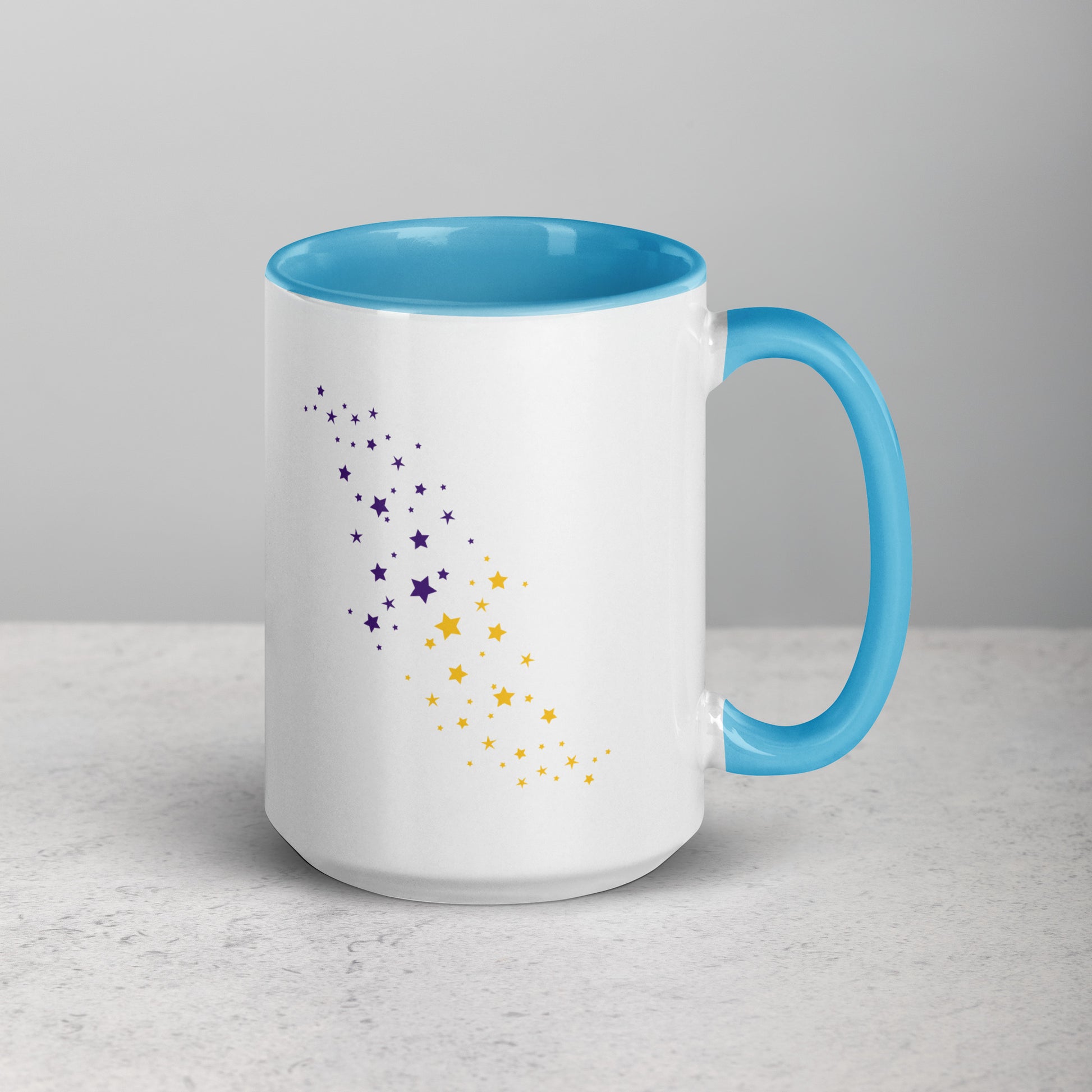White mug with blue interior and handle, featuring purple and yellow star patterns on a light gray background.