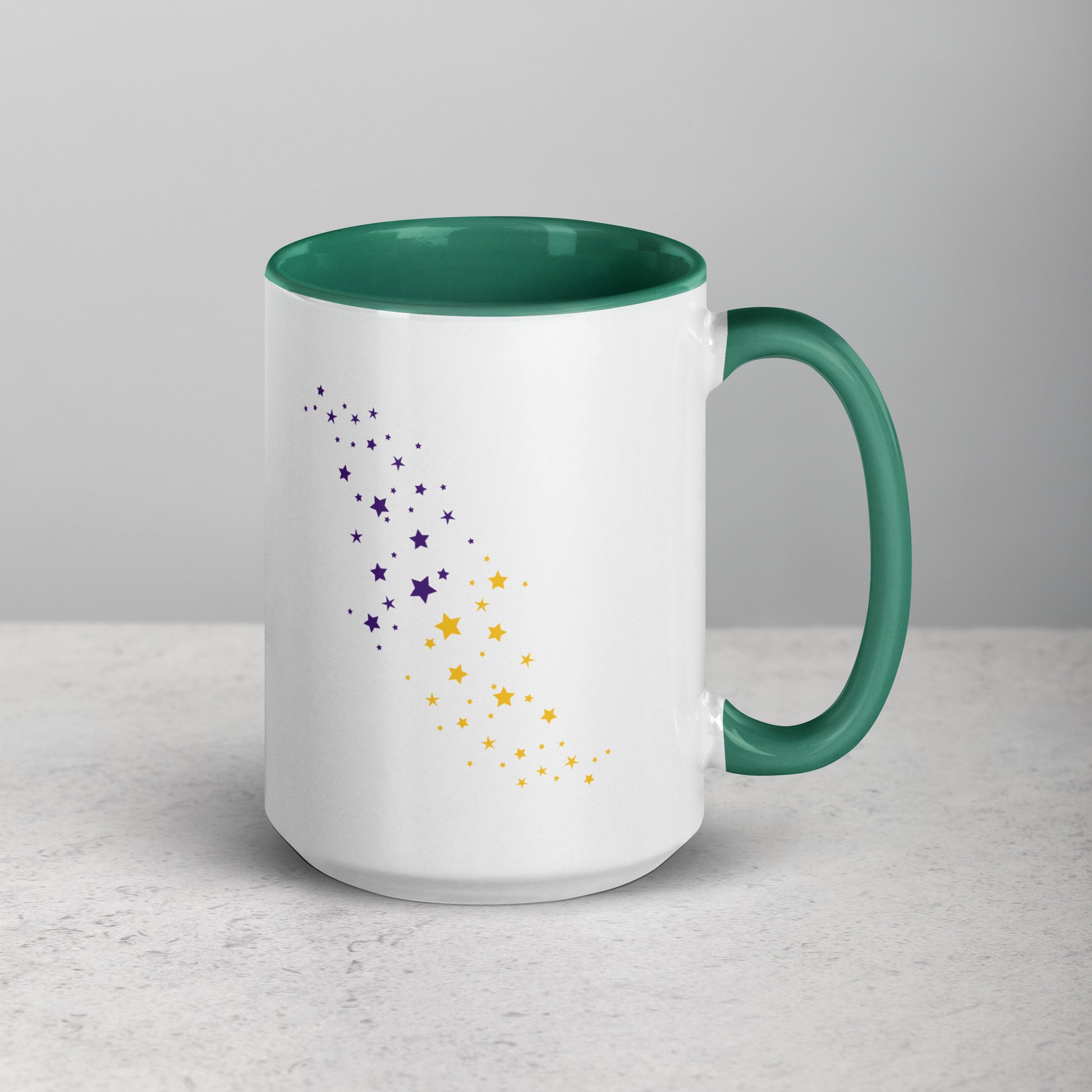 White mug with dark green interior and handle, featuring purple and yellow star patterns on a light gray background.