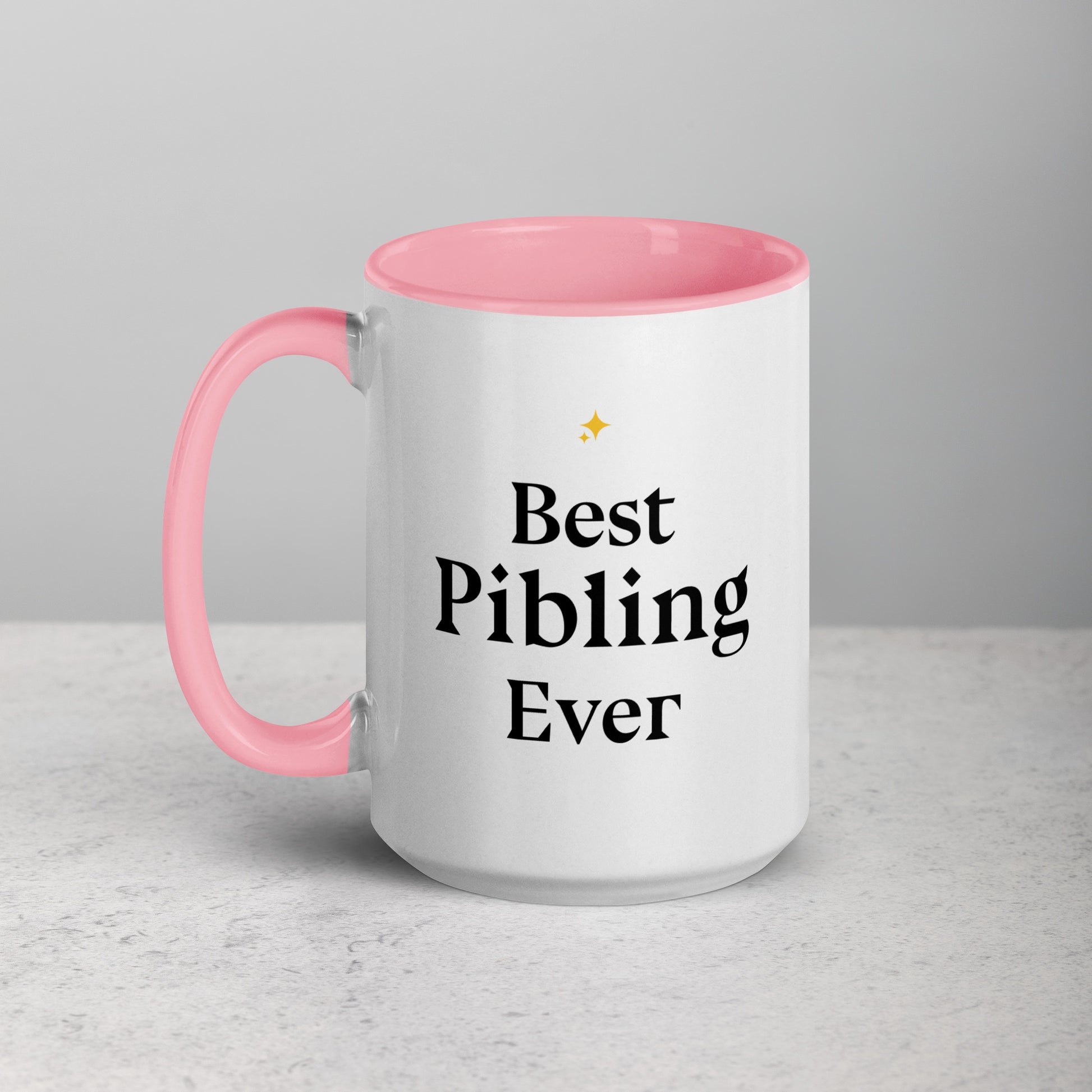 White mug with pink interior and handle, featuring 'Best Pibling Ever' text on a light gray background.