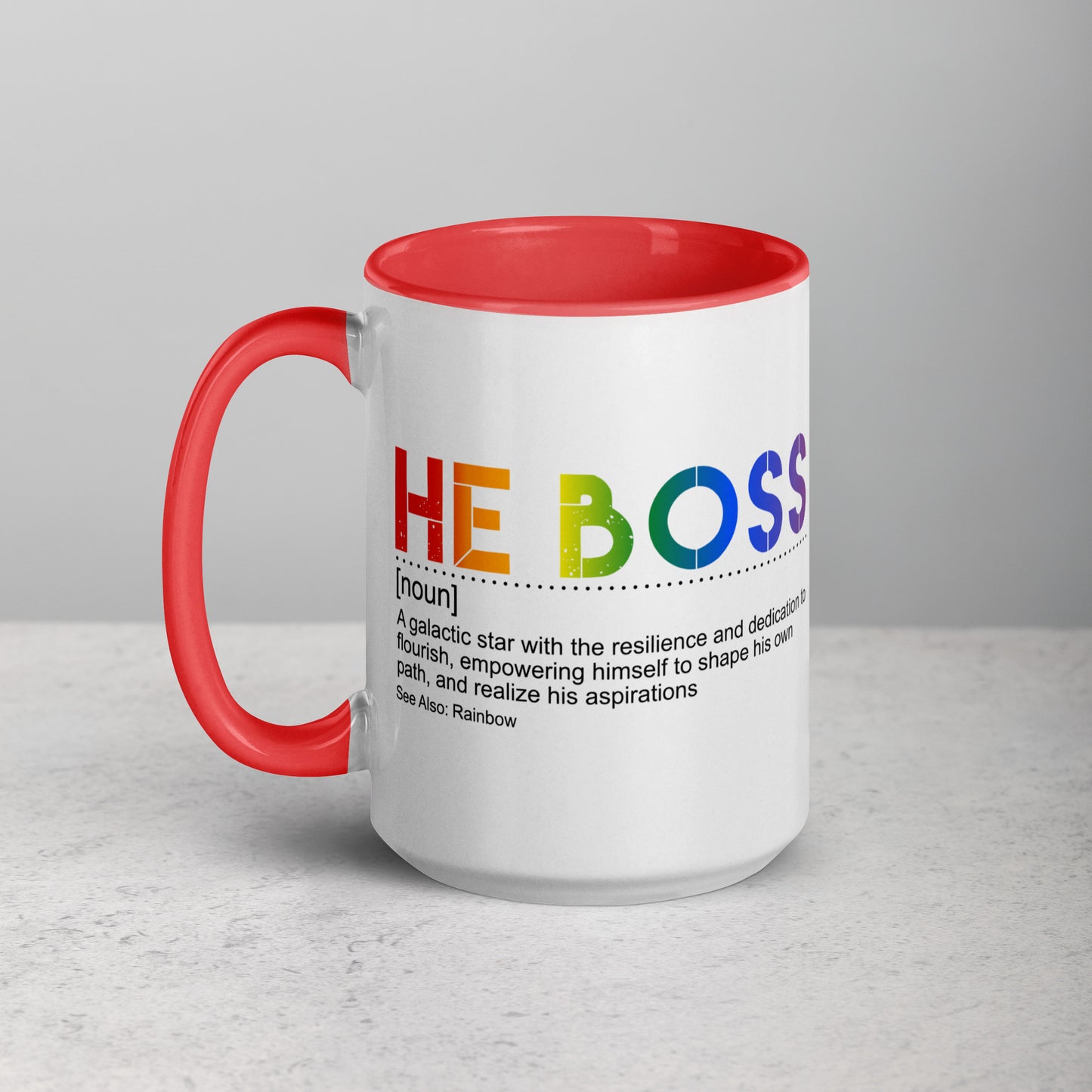 Mug with rainbow-colored letters spelling 'HE BOSS' on a gray background