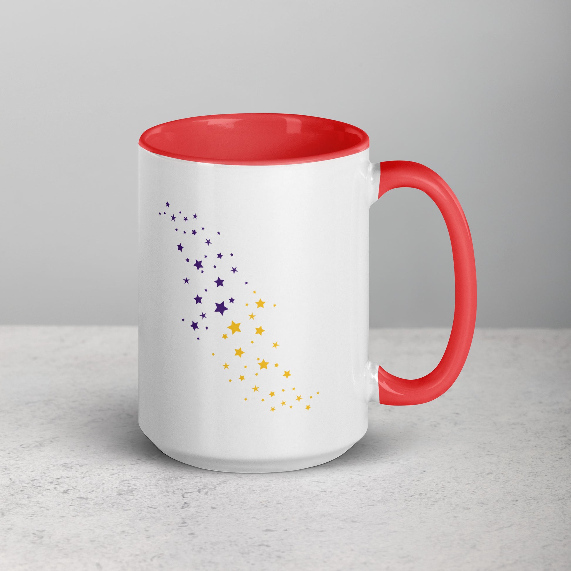 White mug with red interior and handle, featuring purple and yellow star patterns on a light gray background.